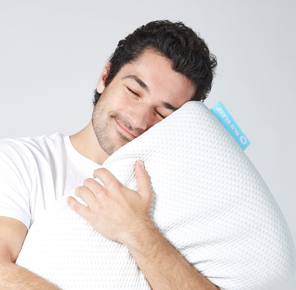 man relaxes with blu pillow